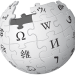 A gray, incomplete globe made of jigsaw puzzle pieces featuring letters and characters from various writing systems, representing the Wikipedia logo.