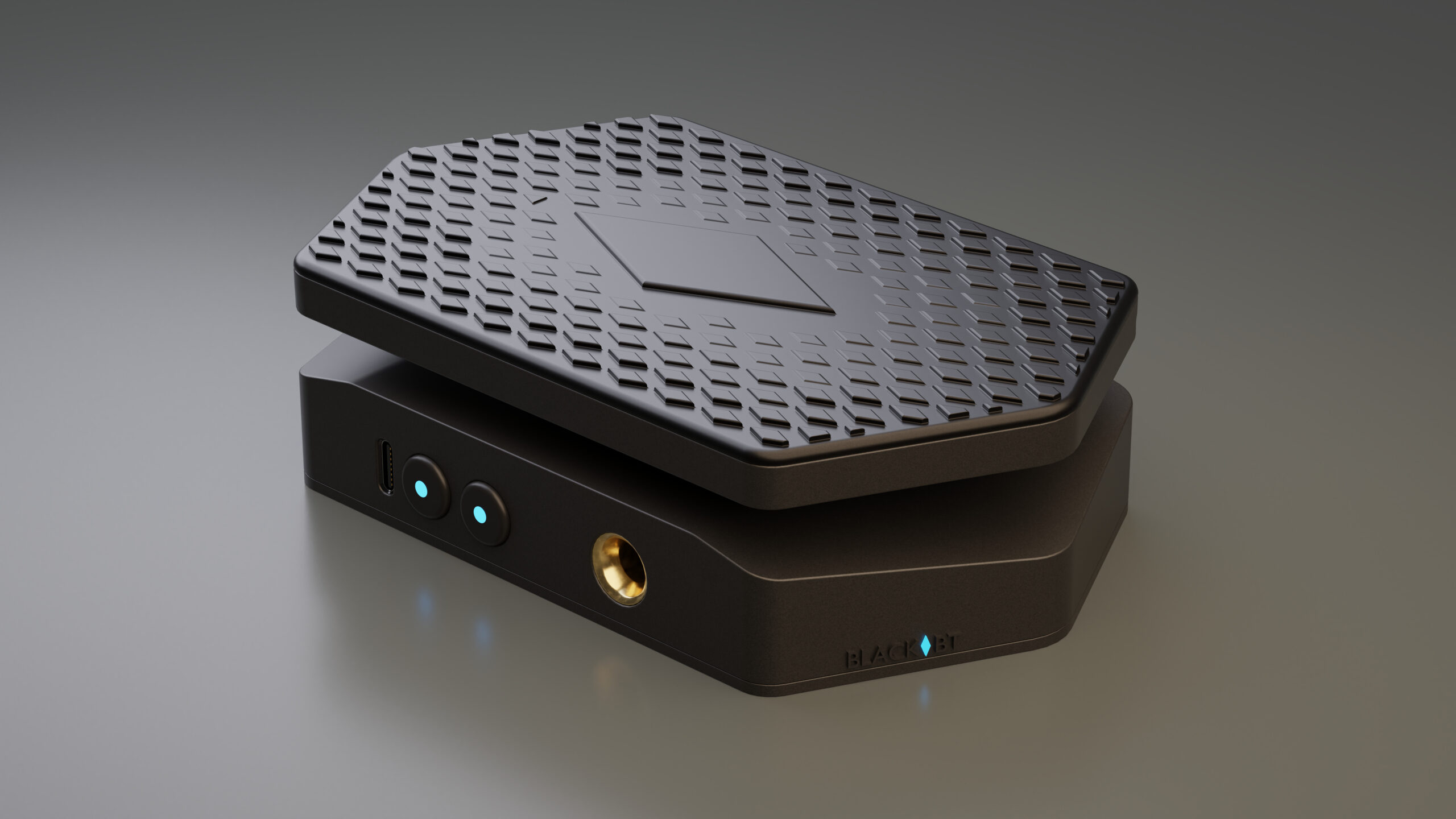 A sleek, black, hexagonal electronic device with a textured top surface, glowing blue indicator lights, and multiple ports on the front and side, placed on a smooth, gray surface.