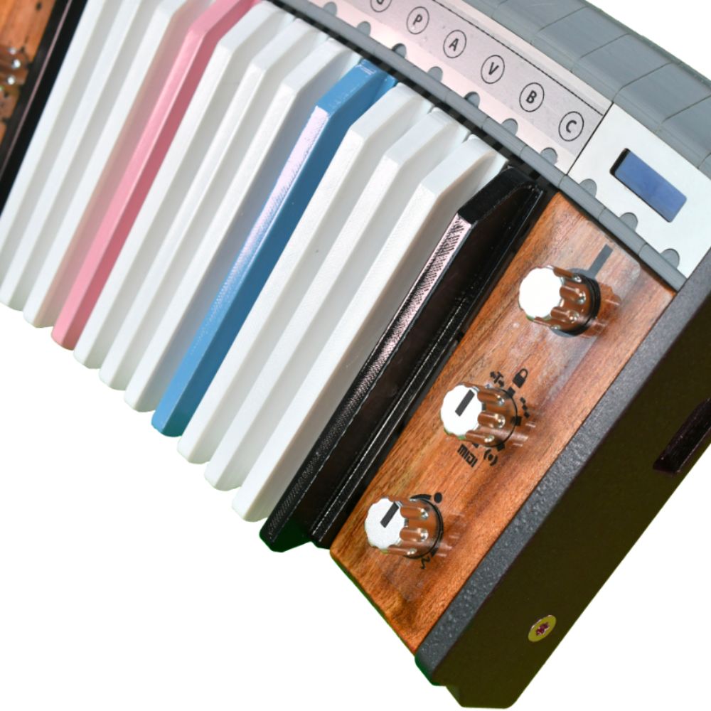 Close-up of a keyboard with colorful keys in white, pink, blue, and black, alongside a wooden panel featuring three silver control knobs and labeled settings.