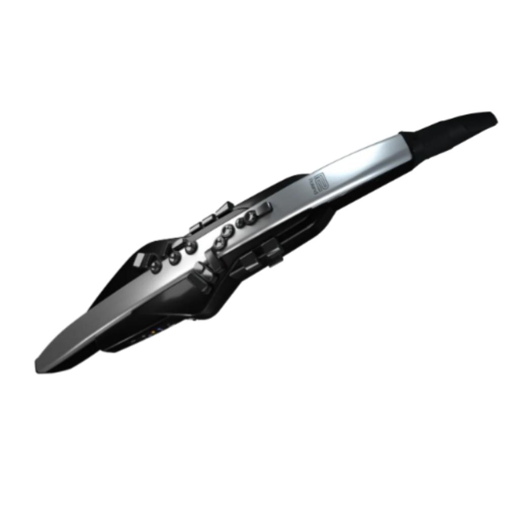 A digital wind instrument with a sleek, elongated black and silver body, featuring several buttons and keys along its surface, photographed against a plain white background.