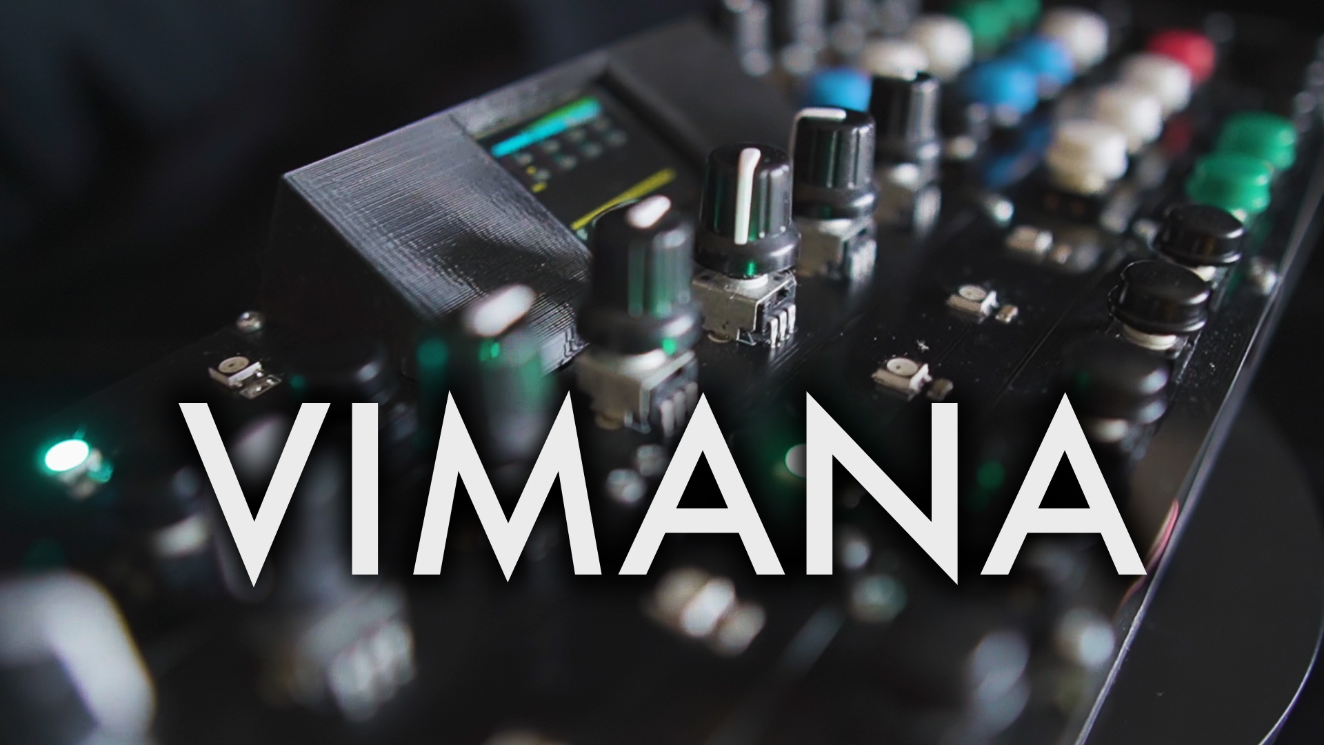 A close-up of an audio mixing console with various knobs, buttons, and lights. The word VIMANA is prominently displayed in bold white letters across the center.