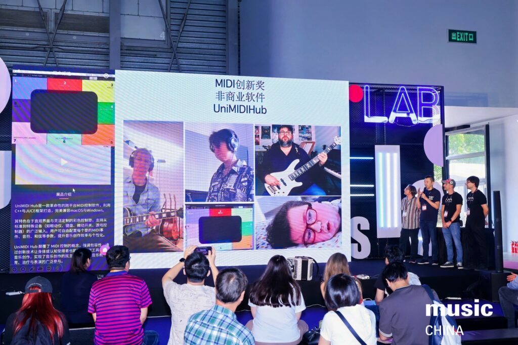 A group of people on stage present an award in front of a large screen displaying photos of musicians and MIDI software information, as an audience watches and takes photos at Music China.