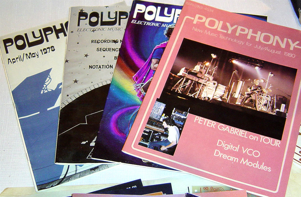 Four issues of Polyphony magazine are spread out, with the top issue featuring a pink cover and a photo of a live music performance. Headlines mention Peter Gabriel, digital VCO, and dream modules.