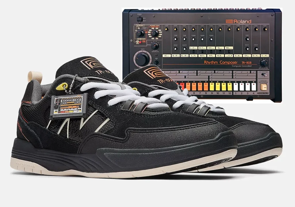 A pair of black New Balance sneakers inspired by the Roland TR-808 drum machine, displayed in front of an image of the TR-808 with orange, yellow, and white details matching the shoes’ accents.