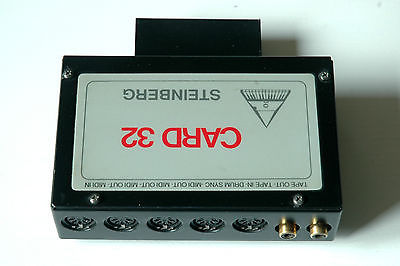 A rectangular black electronic device labeled CARD 32 with the brand name STEINBERG printed upside down. It has multiple round input/output ports and two gold-colored connectors on one side.
