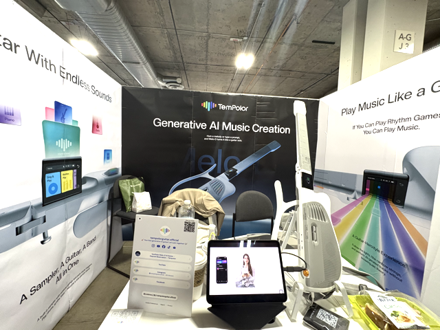 A trade show booth for TenPolar features banners about AI music creation, a guitar graphic, informational displays, and various equipment on tables under industrial ceiling pipes.